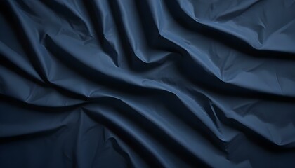 Fototapeta premium Intricate folds and shadows play on a deep blue fabric, creating a sense of luxury.