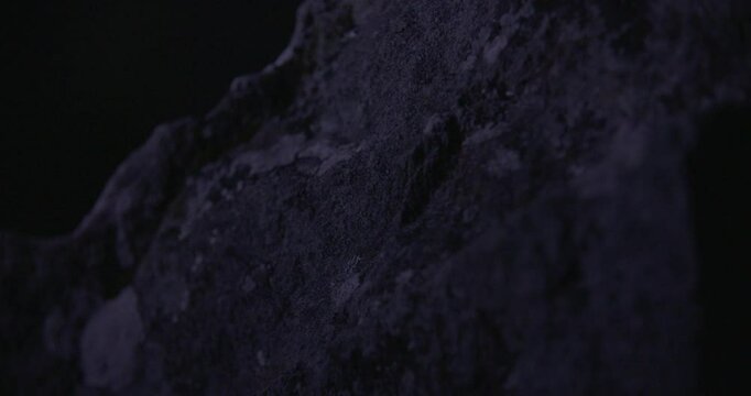 Detailed close-up of rough stone at Drombeg Stone Circle, captured handheld in low light, evoking ancient rituals and quiet reverence.
