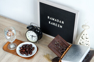 Top View Of Holy Quran, Water, Dates Fruit With Islamic Decoration