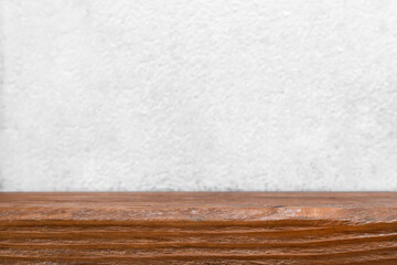 Wooden table. Empty wooden tabletop countertop desk template on white blurred wall backdrop. Empty wooden table mock up copy space. Wooden table surface and white wall