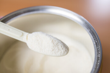 Baby formula scoop with full powder can