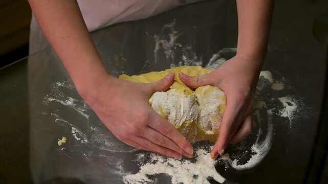 cheff Hands kneading dough on table preparing bread pastry yeast flour Cooking food concept background slow motion. High quality 4k footage