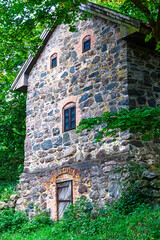 Old stone building showcasing historical architecture in Gothenburg region surrounded by lush...