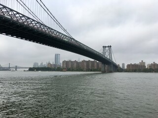 Williamsburg bridge and manhattan skyline on a cloudy and foggy Day.