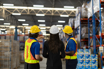 Warehouse workers multi-ethnic discussing work checking inventory and consulting distribution of product at warehouse storage department. Supervisor recommend the inspection and placement of goods