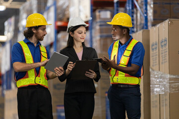 Warehouse workers multi-ethnic discussing work checking inventory and consulting distribution of product at warehouse storage department. Supervisor recommend the inspection and placement of goods