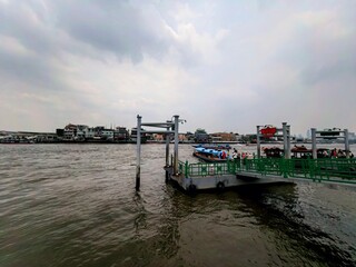Riverside Dock with Boats and City Skyline