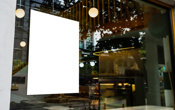 Mockup of white paper poster displayed outside a restaurant or cafe building. Marketing and business concept.