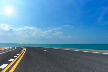 Side view of asphalt road  on sea and beautiful blue sky.