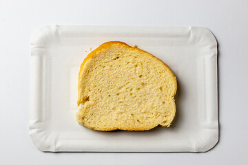 White bread on a white paper plate