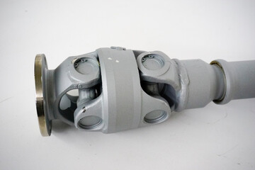 A silver-colored universal joint drive shaft assembly, featuring two universal joints connected by...