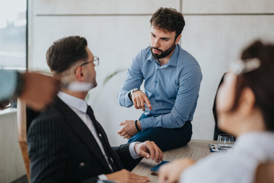 A group of diverse business people having a focused and dynamic meeting in an office setting, fostering teamwork and collaboration.