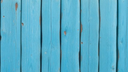 Fototapeta premium A weathered blue wood plank fence background texture shows peeling paint and aged wood grain details for design projects.