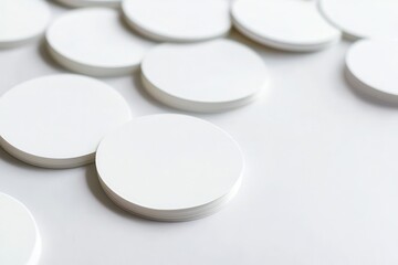 Close-up of stacked blank circular coasters on a smooth surface, ideal for branding projects