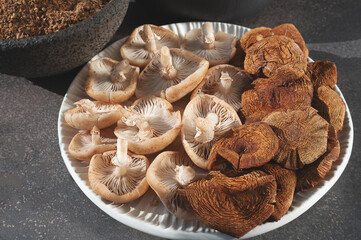 An assortment of fresh mushrooms, dried caps and mushroom powder from opiate mushrooms. Dehydration...