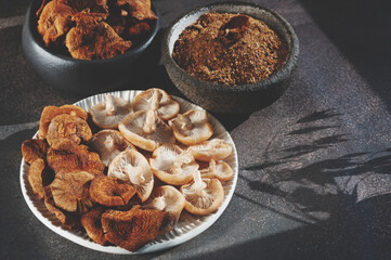 An assortment of fresh mushrooms, dried caps and mushroom powder from opiate mushrooms. Dehydration...