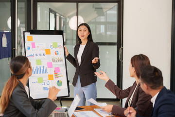 Group of business people are having a presentation meeting in an office room.