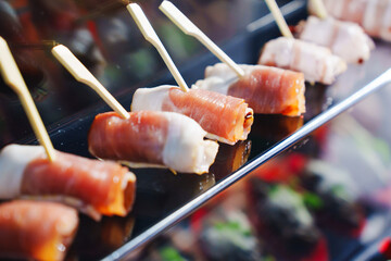 Sushi rolls served on skewers at a market stall during a food festival