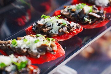 Delicious bruschetta topped with mushrooms and cheese at a culinary event