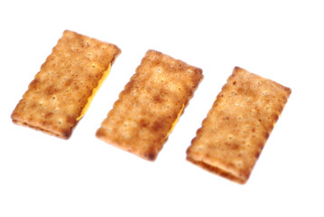 Three crispy biscuit crackers, beautifully arranged and isolated on a clean white background. Concept, a tasty and satisfying snack choice,perfectly crafted for moments of delight anytime, anywhere.  