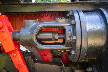 A black and red train engine with a red handle