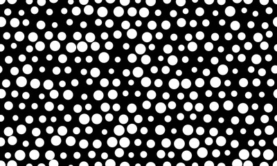 Abstract monochrome pattern of varying sized white circles on a black background.  Perfect for modern design, website backgrounds, textile prints, and digital art projects.