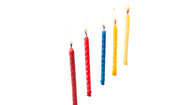 Vibrant birthday candles in various colors lit with flames isolated on transparent background