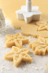 raw cookie dough pressed with cookie cutter