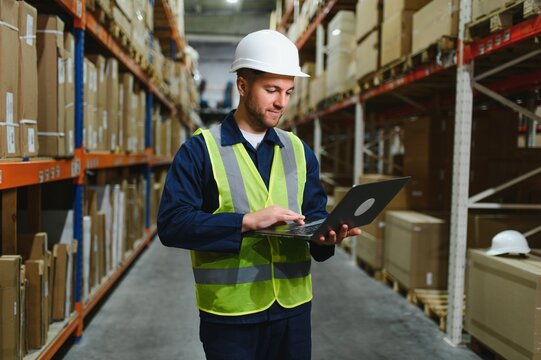 portrait of a smiling young warehouse worker working in a cash and carry wholesale store