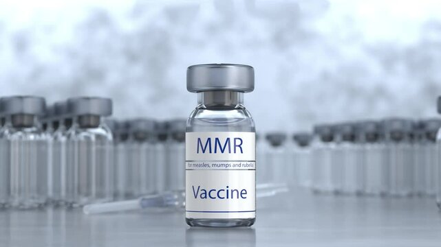 Camera zooming in on MMR vaccine ampoule. Medicine and healthcare concept. Measles, mumps and rubella vaccination. MMR vaccine in glass ampoule. Vials with doses of measles, mumps and rubella vaccine.