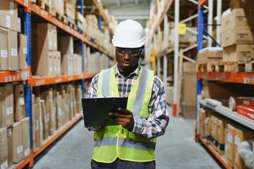 portrait of a young african american warehouse worker working in a cash and carry wholesale store