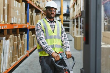 African american Man Driving Fork Lift Truck In Warehouse