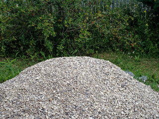 Pile of fine white rubble in the yard of a rural house