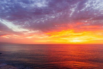 beautiful sunrise or sunset seascape with amazing calm sea water with waves and colorful amazing cloudy morning sky on background