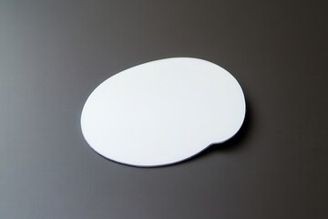 Smooth, white abstract shape on dark surface, ideal for backgrounds or design elements