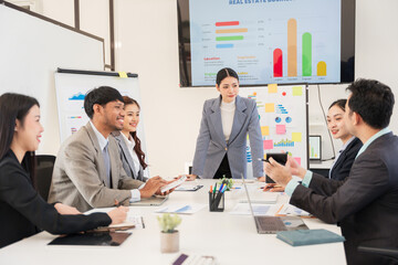 Group of Asian business people meeting, planning, presenting in the office.
