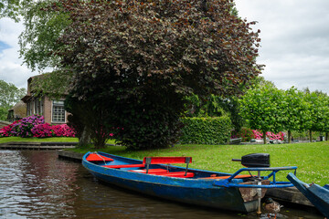 Landscape view of famous Giethoorn village in Netherlands with canals and boat