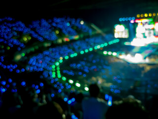 Blurred images of the atmosphere of light, color, sound, and a grand concert performance in a spacious hall.