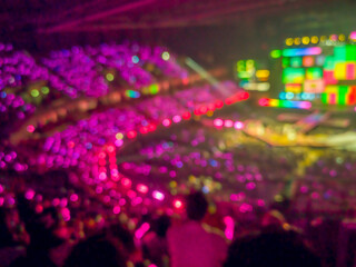 Blurred images of the atmosphere of light, color, sound, and a grand concert performance in a spacious hall.