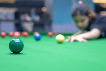 A close-up of the green ball on the snooker table.