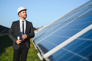 Solar panels. Engineer man on solar power station