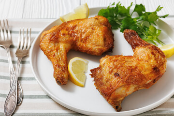 roast chicken legs with crispy skin on a plate