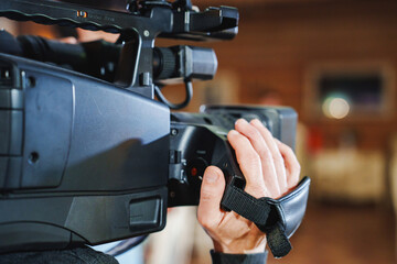 Filmmaker capturing important moments with professional camera in studio setting