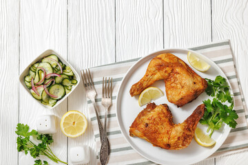 roast chicken legs with crispy skin on a plate