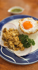 Stir-fried Scallops with garlic with streamed rice serving on blue plate