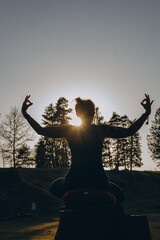 Fit sporty happy young woman wearing sportswear meditating doing yoga breathing stretching...