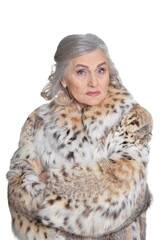 portrait of sad beautiful senior woman in fur coat