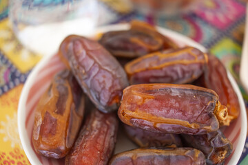 Ramadan background. Delicious iftar. Food on the table: simit, dates, water, dried apricots, cookies