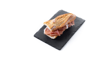 Spanish serrano ham sandwich isolated on white background. Spanish bocadillo de jamon serrano. Copy space