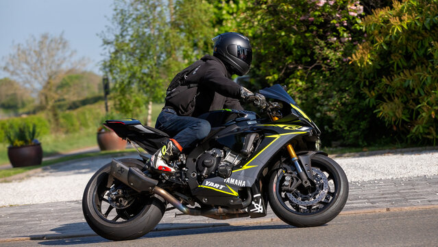 Whittlebury,Northants.,.UK - April 27th 2025:  Man riding a   2015 Yamaha YZF R1 motorcycle on an English country road.